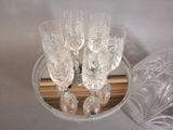 six wine glasses in a glass bowl on a table