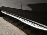 a close up of a black car with a chrome door sill