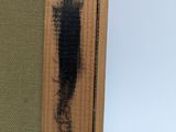 a close up of a picture of a piece of wood with black paint on it