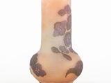 a vase with purple flowers on it on a white surface