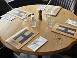 tables and chairs in a restaurant with a view of the street