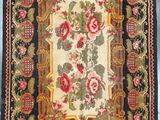 an antique rug with a floral design on a blue background