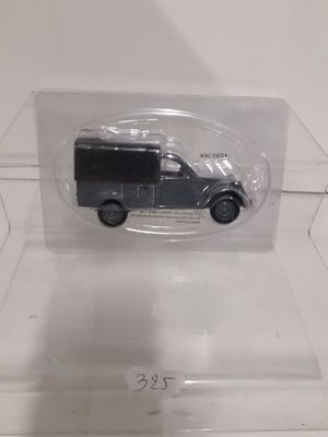 an image of a toy car in a clear box on a white surface
