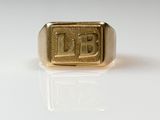 an image of a gold signet ring with the letter b on it