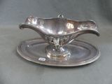 a silver plate with a saucer on it on a table