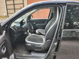 the interior of a car with the door open and the seats down