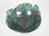 a blue bowl that is sitting on a white surface