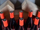 several bottles of red wine in a wooden crate on a table