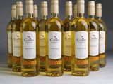six bottles of white wine are lined up in a row