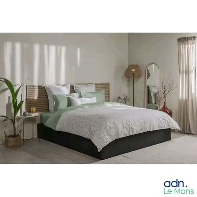 a picture of a bedroom with a bed and a mirror