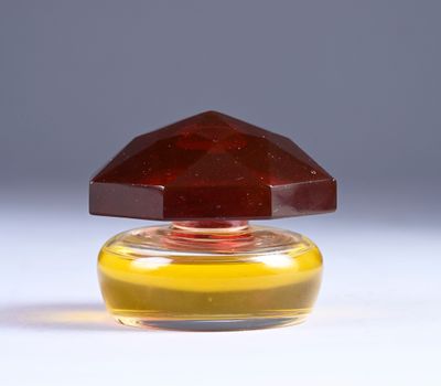 a bottle of perfume with a brown cap on it