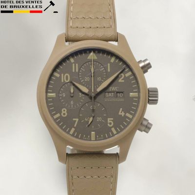 an image of a watch with a tan leather strap on a white background