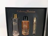 two bottles of perfume in a black box on a white surface