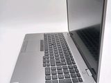 a silver laptop with a black keyboard on a white surface