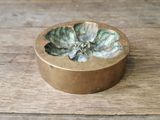 a small gold bowl with a succulent plant in it