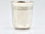silver plated cup on white surface with reflection on white surface