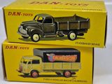 two boxes of dan - toy trucks sitting on top of each other