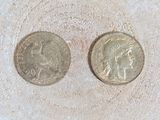 two coins that are sitting in the sand