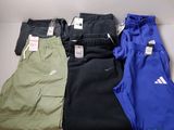 three pairs of men ' s nike sweatpantss and a pair of pants