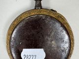 an old pocket watch with a tag on it