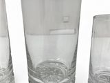 three glasses sitting next to each other on a white surface