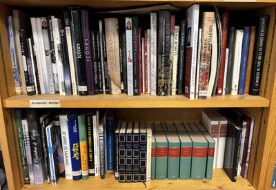 a book shelf with many books on it in a library