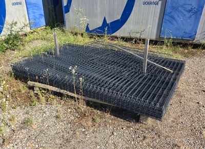an image of a grate laying on the ground in front of a building
