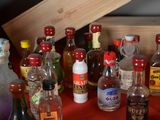 many bottles of alcohol sitting on a red table