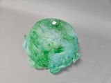 a close up of a green object on a white surface