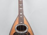a close up of a guitar on a stand against a white background