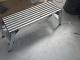 a metal bench that is sitting in a room