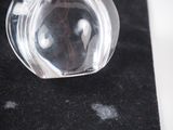 a clear glass bottle with a face inside of it
