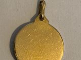 a close up of a gold coin on a white surface