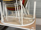 many chairs stacked on top of each other in a room