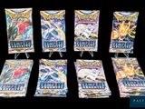six packs of pokemon trading cards on display on a black background