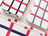 three pieces of red, white and blue checkered napkins on a white surface