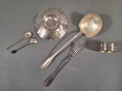 a lot of silver spoons and spoons on the table