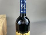 a bottle of wine sitting on a table next to a box
