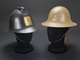 two helmets are sitting on top of each other on a black surface