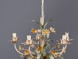 an image of a chandelier with flowers and candles hanging from the ceiling