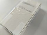 a white box on a table with a glass on it