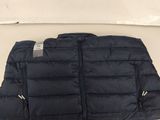 a close up of a black puffy vest on a white surface