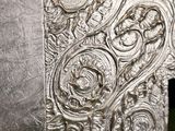 a large metal object with a design on it