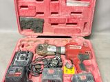a red tool case with tools in it on a table
