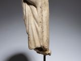 a statue of a woman with a veil on a wooden stand