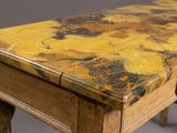 a marble top table with wooden legs and a drawer
