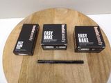 three boxes of easy bake on a wooden table with a pencil