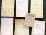 several old books sitting on top of a table next to each other