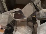 many pieces of silver on a shelf in a room
