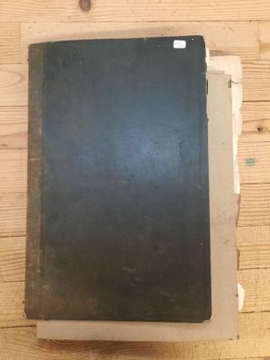 a black book sitting on top of a wooden table